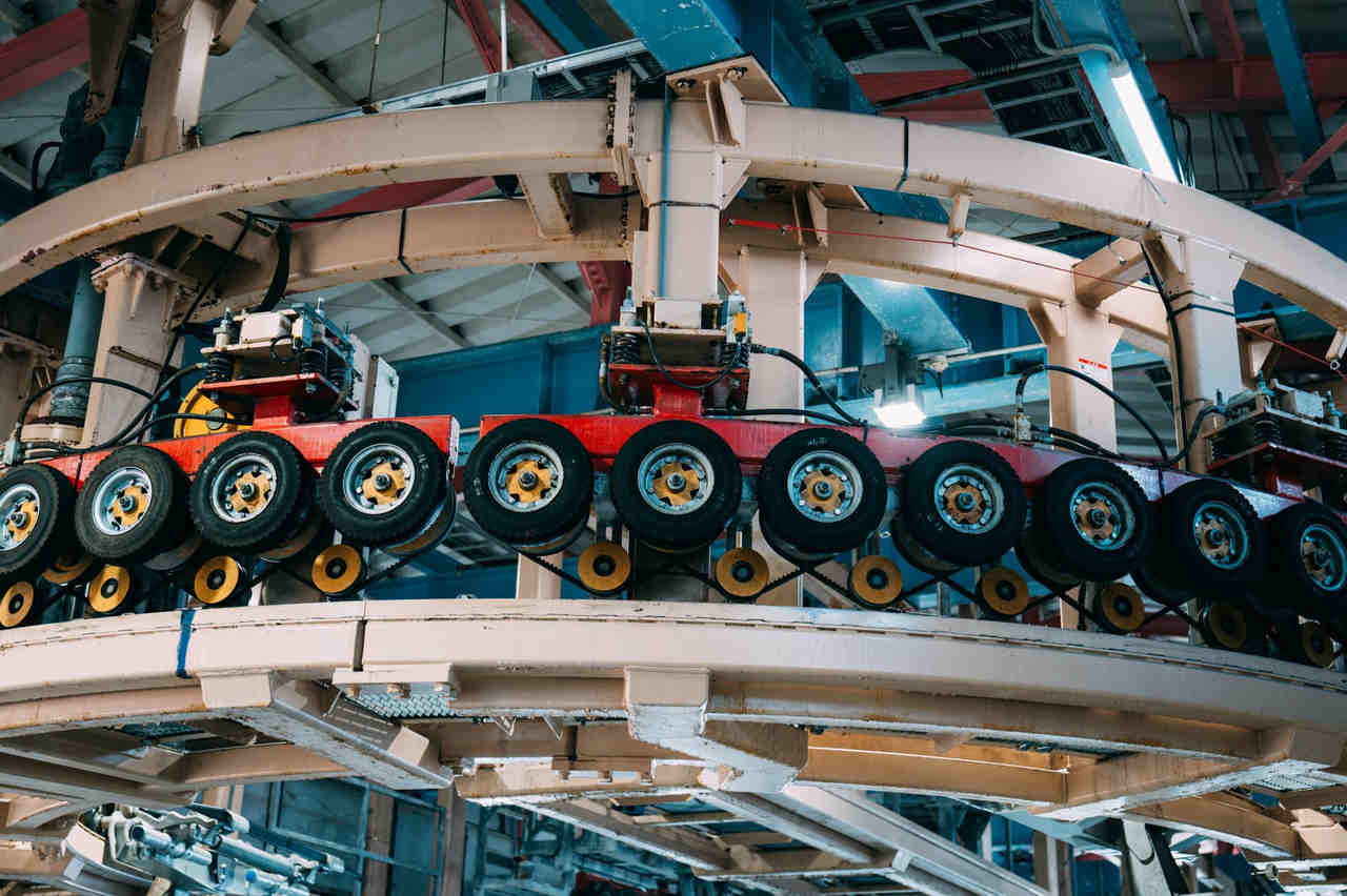 Close-up view of a complex industrial conveyor system inside a manufacturing facility.